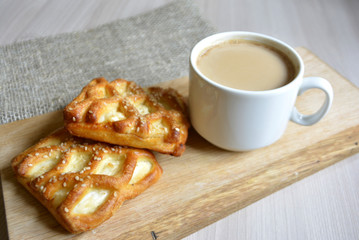 a cup of coffee with milk and baked 