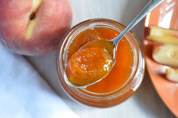 Peach apricot jam in a spoon top view