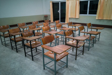 Fototapeta na wymiar University classroom with many wooden chairs