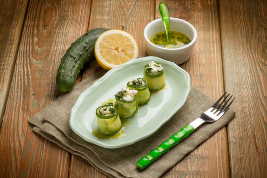 filled sliced cucumber with fresh cheese and lemon and oil sauce