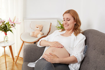 Pregnant woman in living room