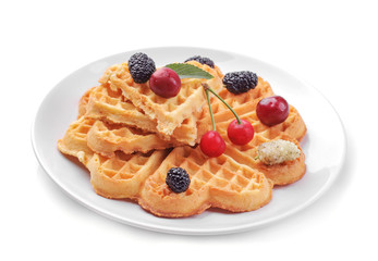 Delicious sweet Belgian waffles in the form of hearts with berries on a white isolated background.