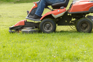 lawn mower tractor working in the town park