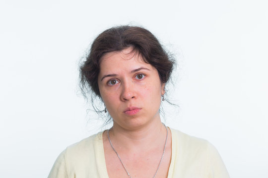 Portrait of sad woman standing on white background