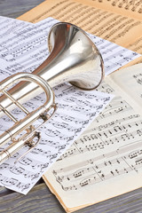 Trumpet and musical notes, vertical image. Musical background with classical instrument. Retro music concept.