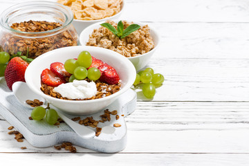 delicious healthy breakfast with fruits, granola on white background