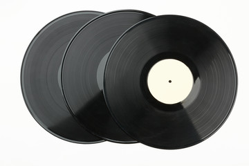 Vinyl records over white background. Three vinyl plates. Retro musical equipment.