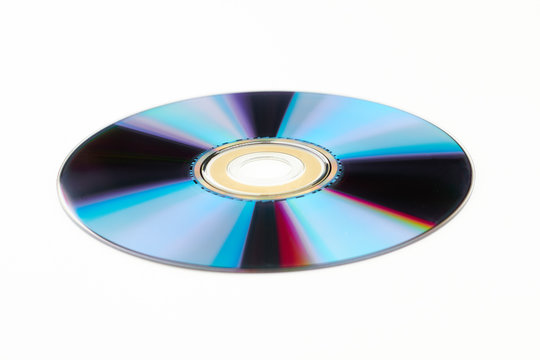 Shining DVD disc for computer. Colorful DVD disk isolated on white background. Compact digital disc.