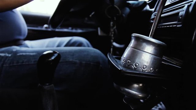 Driver Drinking Argentine Mate while Driving.