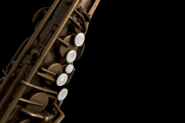 Fototapeta premium Matte finish saxophone with pearl keys on black background