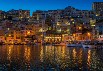 The picturesque city of Sciacca in the evening overlooking its harbour. Province of Agrigento, Sicily. - obrazy, fototapety, plakaty
