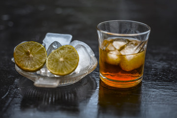 Close up of hangover remedy i.e. lemon juice on wooden surface with Scotch or Scotch whiskey or Grain whiskey.