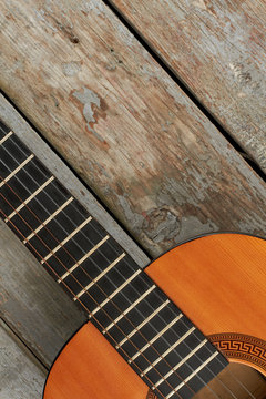 Acoustic guitar and copy space. Wooden guitar on old wooden planks, cropped image.