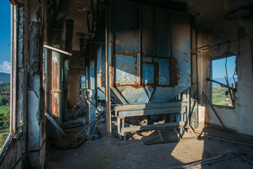 Fototapeta na wymiar Abandoned flour milling factory. Rusty grain bunkers