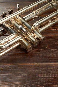 Detail of old trumpet instrument. Close up trumpet on wooden background with copy space. Classical orchestral instrument.