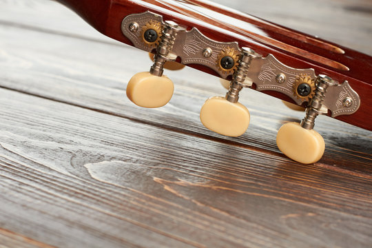 Head of acoustic guitar close up. Head details of classical guitar. Macro view on part of classical musical instrument.