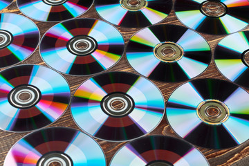 Background of colorful compact discs. Lots of colorful compact disks. Digital storage of information.