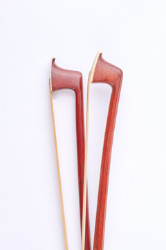 Brown violin fiddle stick, top view. Fiddle stick for classical violin over white background. Wooden violin bow.