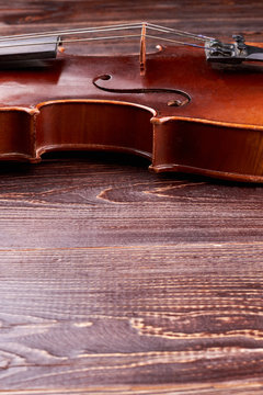 Old violin instrument and copy space. Vintage violin on textured wooden background, vertical image.