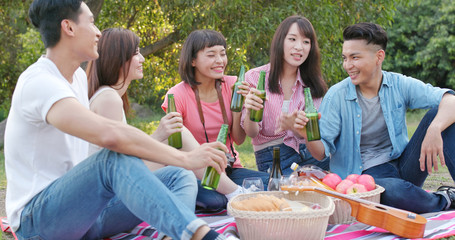 Asian Young friends enjoy the picnic time in the park