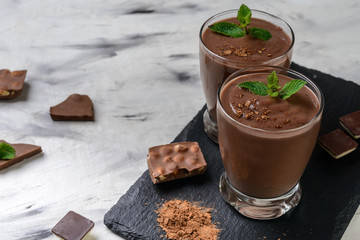 Chocolate  smoothie (pudding) with mint  in  glasses   on a grey background.