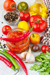 Tomato paste, sauce in glass jar and fresh tomatoes