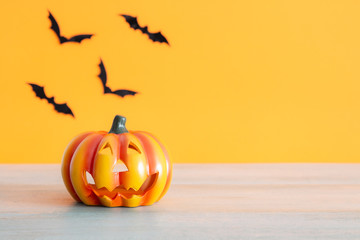 Pumpkin and bats with orange background. Halloween concept.