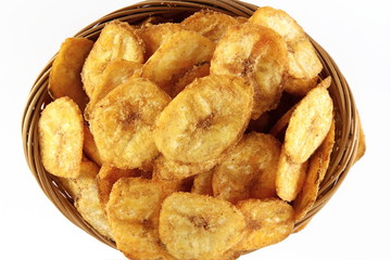 spicy salty banana chips or wafers with herbs masala traditional indian gujarati snack isolated on a white background