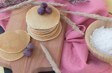 pancakes with grapes on textures and flowers