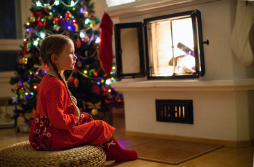 Little girl at home on Christmas eve