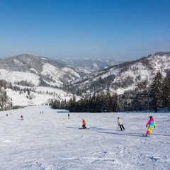 Skiers on the mountain slope on a background of mountains