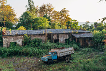 Old rusty truck at abandoned overgrown industrial area. Aerial view