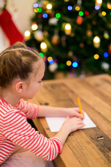Little girl writing mail to Santa