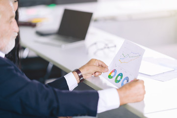 Manager and adult assistant brainstorming in office,Leader discussion on document paper