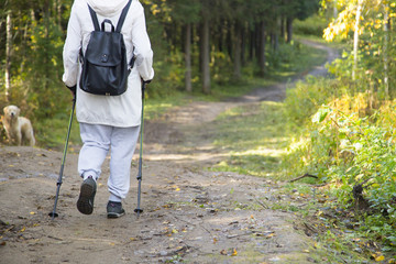 woman practicing nordic walking in nature