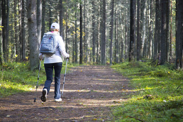 woman practicing nordic walking in nature