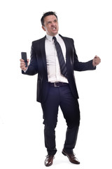 Obraz premium Young man wearing a a dark suit, white shirt and black tie, smiling holding a smart phone and a briefcase, isolated on white background.