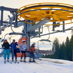 Blurred in motion people skiing from ski lift at winter carpathian mountains