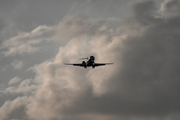 Fototapeta na wymiar High contrast of jet plane against clouds