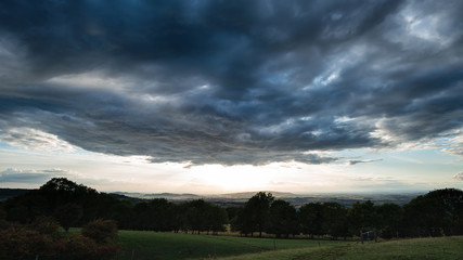 Beautiful dramatic Summer sunset landscape over English countryside with stunning light