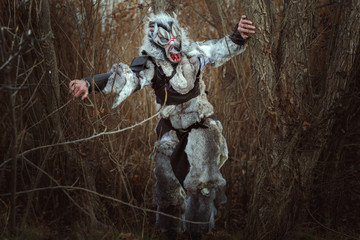 Terrible creature resembling a human wolf in the forest.
