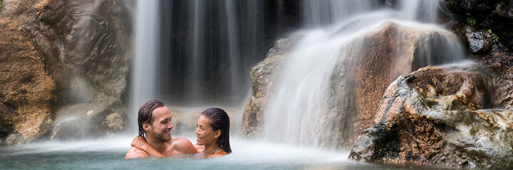 Vacation couple relaxing in waterfall banner. Romantic destination travel holidays people happy...