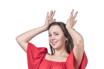 Woman in red dress holds an imaginary crown on her head, isolated on white background