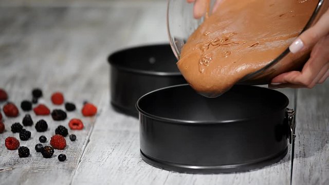 Pouring cake batter onto baking sheet. Making Chocolate Layer Cake.