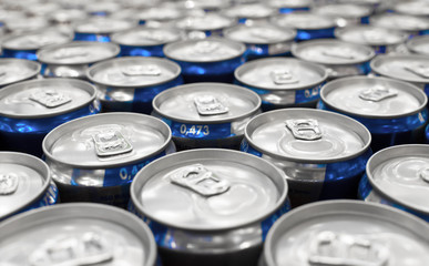 Set of aluminum cans with a drink on the supermarket counter