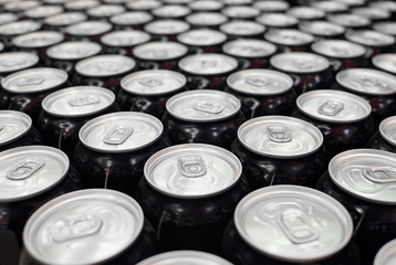Set of aluminum cans with a drink on the supermarket counter