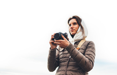 professional photographer tourist traveler standing on background holding in hands digital photo camera, hiker view from front taking photography, closeup girl enjoy relax holiday hobby concept