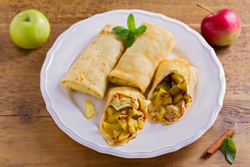 Apple cinnamon crepes. Pancakes with caramelized apples and cinnamon