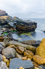 The photo of the stone on the beach on the long exposure