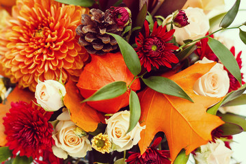 Autumn bouquet with aster flowers and dry leaves isolated on white